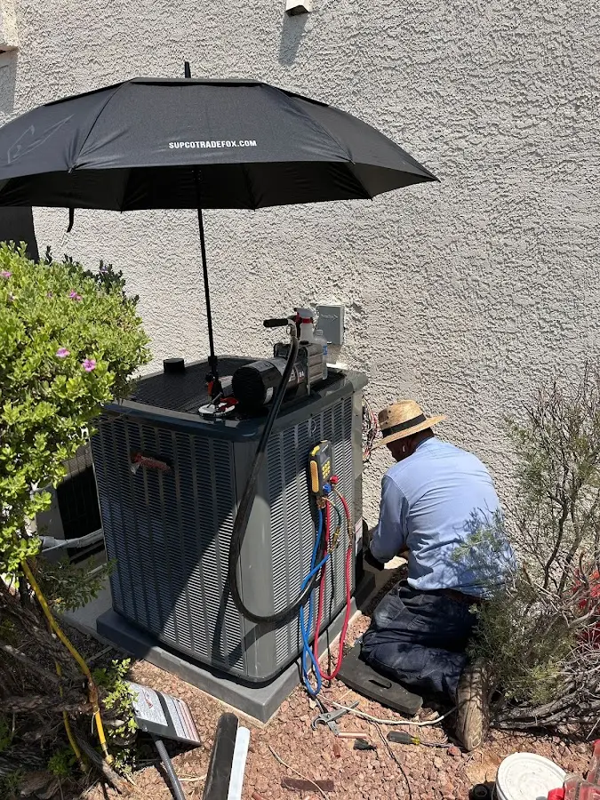 HVAC technician performing outdoor AC maintenance in Apple Valley
